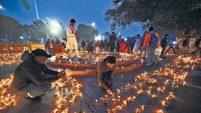 People light diyas to celebrate the consecration of the Ram Temple in Ayodhya, at Connaught Place on Monday. (Sanchit Khanna/HT Photo)