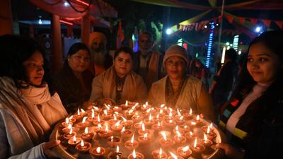 People light lamps at Sanatan Dharma Mandir, in Noida’s Sector 19, to mark the Pran Pratishtha (life establishment) of Ram Lalla idol in Ayodhya, on Monday. (Sunil Ghosh/HT Photo)