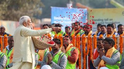Prime Minister Narendra Modi showers flower petals on workers who were a part of the construction crew at the Ram Temple. (ANI) Prime Minister Narendra Modi showers flower petals on workers who were a part of the construction crew at the Ram Temple. (ANI)