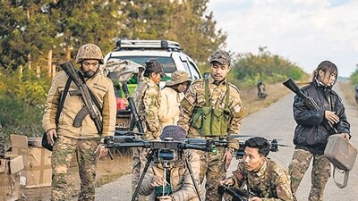 TOPSHOT - This photo taken on December 11, 2023 shows members of the Mandalay People’s Defense Forces (MDY-PDF) preparing to release a drone near the frontline amid clashes with Myanmar's military in northern Shan State. A squad of Myanmar pro-democracy fighters works quickly to ready drones for an attack on a nearby military base, the latest target in a wave of aerial assaults that has helped turn the war against the junta. (Photo by AFP) / TO GO WITH Myanmar-coup, FOCUS (AFP)