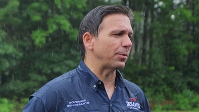 U.S. Republican presidential candidate Florida Governor Ron DeSantis talks to reporters after walking in the Fourth of July Parade in the rain in Merrimack, New Hampshire, U.S., July 4, 2023. (REUTERS)