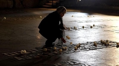 A woman places a flower at the Hall of Remembrance where the names of major killing sites of Jews are written during a Holocaust Remembrance Day ceremony at the Yad Vashem Holocaust Museum in Jerusalem. (AFP File Photo) A woman places a flower at the Hall of Remembrance where the names of major killing sites of Jews are written during a Holocaust Remembrance Day ceremony at the Yad Vashem Holocaust Museum in Jerusalem. (AFP File Photo)
