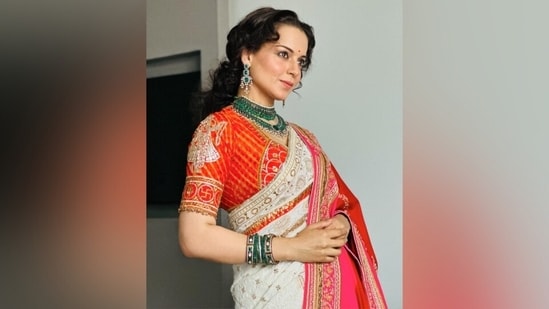 Kangana styled the saree with a Bandhani blouse in orange and red hues, decked with gold and silver gota patti embroidery and half-length sleeves. She styled the traditional look with a heavily embroidered shawl in red and pink shades.&nbsp;(Instagram)