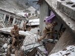 Chinese military police and rescue workers searching for missing victims at a landslide site in Liangshui village in Zhaotong, in southwestern China's Yunnan province. Chinese military police and rescue workers searching for missing victims at a landslide site in Liangshui village in Zhaotong, in southwestern China's Yunnan province.