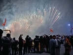 People click photos of fireworks at Saryu Ghat on the occasion of Pran Pratishtha ceremony of Ram Mandir on Monday. (ANI)