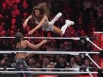 Wrestler Carmella leaps at Bianca Belair, during the WWE Monday Night RAW event(AP)
