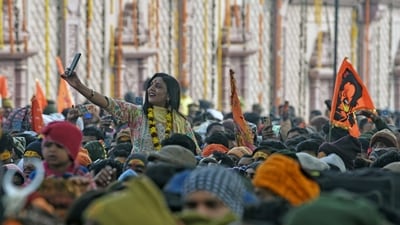 The temple gates, adorned with flowers and lights, became popular spots for selfies as devotees gathered in line. (ANI) The temple gates, adorned with flowers and lights, became popular spots for selfies as devotees gathered in line. (ANI)