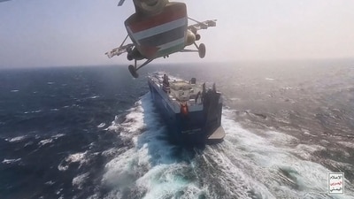 This photo released by the Houthi Media Center shows a Houthi forces helicopter approaching the cargo ship Galaxy Leader on Sunday, Nov. 19, 2023. Yemen's Houthis have seized the ship in the Red Sea off the coast of Yemen after threatening to seize all vessels owned by Israeli companies. AP/PTI(AP11_21_2023_000102A) (AP) This photo released by the Houthi Media Center shows a Houthi forces helicopter approaching the cargo ship Galaxy Leader on Sunday, Nov. 19, 2023. Yemen's Houthis have seized the ship in the Red Sea off the coast of Yemen after threatening to seize all vessels owned by Israeli companies. AP/PTI(AP11_21_2023_000102A) (AP)