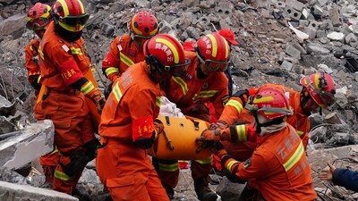 China Landslide: Rescue workers carry a corpse found in the area of a landslide in Liangshui village in Zhaotong, in southwestern China's Yunnan province. (AFP) China Landslide: Rescue workers carry a corpse found in the area of a landslide in Liangshui village in Zhaotong, in southwestern China's Yunnan province. (AFP)