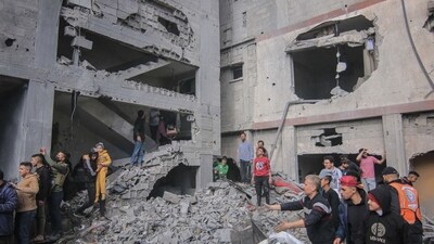 Palestinians amongst the rubble of buildings hit by an Israeli airstrike in Khan Younis, southern Gaza. (Bloomberg)