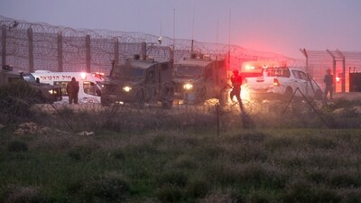 Israeli soldiers walk next to military vehicles and ambulances, as the conflict continues between Israel and the Palestinian group Hamas (REUTERS)