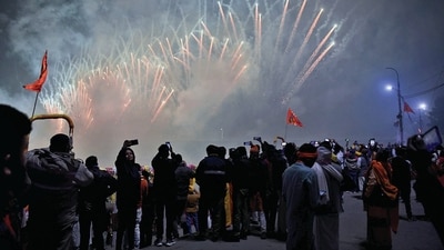 People click photos of fireworks at Saryu Ghat on the occasion of Pran Pratishtha ceremony of Ram Mandir on Monday. (ANI) People click photos of fireworks at Saryu Ghat on the occasion of Pran Pratishtha ceremony of Ram Mandir on Monday. (ANI)
