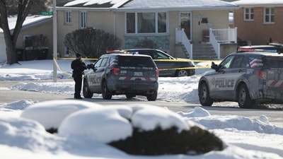 Police work at the scene of a shooting in Tinley Park on Sunday. Authorities have identified a woman and her three adult daughters who were found slain inside their suburban Chicago home. (AP) Police work at the scene of a shooting in Tinley Park on Sunday. Authorities have identified a woman and her three adult daughters who were found slain inside their suburban Chicago home. (AP)