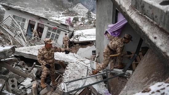 Chinese military police and rescue workers searching for missing victims at a landslide site in Liangshui village in Zhaotong, in southwestern China's Yunnan province. (AFP)