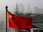 FILE - A Chinese national flag flutters against office buildings in Shanghai, China, on April 14, 2016. China faces international scrutiny Tuesday, Jan. 23, 2024, over domestic polices in places like Hong Kong, Tibet and the western Xinjiang region as the global power receives its latest U.N.-backed review of its human rights record. (AP Photo/Andy Wong, File) FILE - A Chinese national flag flutters against office buildings in Shanghai, China, on April 14, 2016. China faces international scrutiny Tuesday, Jan. 23, 2024, over domestic polices in places like Hong Kong, Tibet and the western Xinjiang region as the global power receives its latest U.N.-backed review of its human rights record. (AP Photo/Andy Wong, File)