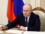 Russian president Vladimir Putin chairs a meeting.