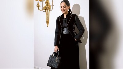 To complete her look, Sonam opted for a black classy Dior handbag, a pair of dazzling gold statement earrings and stylish shiny black leather boots, which perfectly complemented her head-turning look. (Instagram/@sonamkapoor) To complete her look, Sonam opted for a black classy Dior handbag, a pair of dazzling gold statement earrings and stylish shiny black leather boots, which perfectly complemented her head-turning look. (Instagram/@sonamkapoor)
