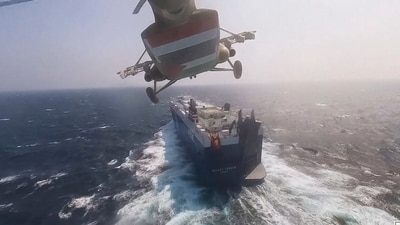 A Houthi forces helicopter approaching the cargo ship Galaxy Leader. (AP) A Houthi forces helicopter approaching the cargo ship Galaxy Leader. (AP)
