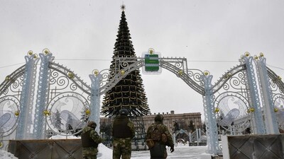 Territorial defence unit volunteers patrol the central square of Belgorod. (AFP) Territorial defence unit volunteers patrol the central square of Belgorod. (AFP)