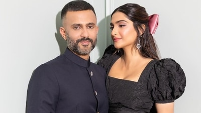 Sonam wore a floor-length Dior dress with diamond earrings while Anand chose an Indian attire - a powder blue kurta with white churidaar and a black bandhgala for the outing. Sonam wore a floor-length Dior dress with diamond earrings while Anand chose an Indian attire - a powder blue kurta with white churidaar and a black bandhgala for the outing. 