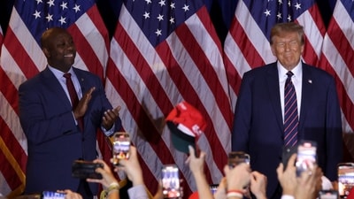 U.S. Sen Tim Scott (R-SC) applauds alongside Republican presidential candidate and former U.S. President Donald Trump during Trump's primary night rally at the Sheraton on January 23, 2024 in Nashua, New Hampshire. (Getty Images via AFP) U.S. Sen Tim Scott (R-SC) applauds alongside Republican presidential candidate and former U.S. President Donald Trump during Trump's primary night rally at the Sheraton on January 23, 2024 in Nashua, New Hampshire. (Getty Images via AFP)