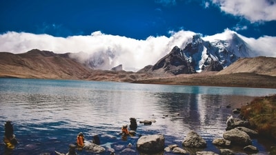 Gurudongmar, Sikkim: Gurudongmar Lake is one of the highest lakes in the world, located at an altitude of 17,800 feet in North Sikkim. The lake is named after Guru Padmasambhava and is considered sacred by both Buddhists and Sikhs. Surrounded by snow-capped mountains, including the majestic Kanchenjunga, the lake offers stunning views of the Himalayan landscape. The clear blue waters of the lake are a sight to behold, reflecting the beauty of the surrounding peaks. (Unsplash) Gurudongmar, Sikkim: Gurudongmar Lake is one of the highest lakes in the world, located at an altitude of 17,800 feet in North Sikkim. The lake is named after Guru Padmasambhava and is considered sacred by both Buddhists and Sikhs. Surrounded by snow-capped mountains, including the majestic Kanchenjunga, the lake offers stunning views of the Himalayan landscape. The clear blue waters of the lake are a sight to behold, reflecting the beauty of the surrounding peaks. (Unsplash)