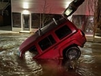 A Washington couple was in for horror when their car plunged into a sinkhole in a Vancouver intersection while returning home last week (@VancouverPDUSA/X)