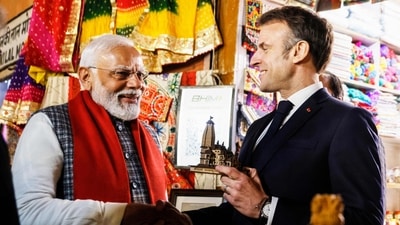 Prime Minister Narendra Modi offers a replica of Ram temple to France's President Emmanuel Macron (AFP) Prime Minister Narendra Modi offers a replica of Ram temple to France's President Emmanuel Macron (AFP)