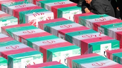 A man mourning over coffins draped with the Iranian flag during the funeral of victims killed in twin blasts on January 3. (AFP) A man mourning over coffins draped with the Iranian flag during the funeral of victims killed in twin blasts on January 3. (AFP)