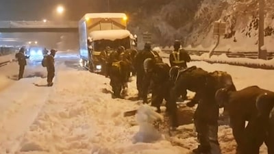 In this photo provided by the Japan Ground Self-Defense Force, its members clear snow off to make enough space for vehicles to move on an expressway near or in Sekigahara, central Japan, Wednesday, Jan. 24. 2024, following heavy snow in the area. Weather officials in Japan predicted more heavy snow Thursday, a day after nearly 800 vehicles were trapped for hours on an expressway in central Japan. (AP) In this photo provided by the Japan Ground Self-Defense Force, its members clear snow off to make enough space for vehicles to move on an expressway near or in Sekigahara, central Japan, Wednesday, Jan. 24. 2024, following heavy snow in the area. Weather officials in Japan predicted more heavy snow Thursday, a day after nearly 800 vehicles were trapped for hours on an expressway in central Japan. (AP)