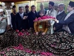 France's President Emmanuel Macron takes part in rituals during his visit of a mausoleum at the Nizamuddin