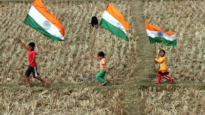 Children carrying national flags run through the field on the eve of Republic Day in South Dinajpur. (Mansur Mandal) Children carrying national flags run through the field on the eve of Republic Day in South Dinajpur. (Mansur Mandal)