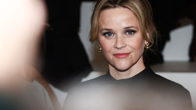 Reese looked ‘Parisian chic’ in a simple black dress, letting her red lip make a statement (Emmanuel Dunand / AFP) Reese looked ‘Parisian chic’ in a simple black dress, letting her red lip make a statement (Emmanuel Dunand / AFP)