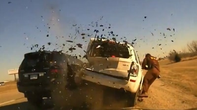 A horrifying moment caught on camera shows how an Oklahoma highway patrol officer was sent flying into the air after a vehicle slammed into the car he had pulled over (@CollinRugg/X) A horrifying moment caught on camera shows how an Oklahoma highway patrol officer was sent flying into the air after a vehicle slammed into the car he had pulled over (@CollinRugg/X)