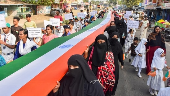School students carry a 200-feet long national flag during a procession taken out on the 75th Republic Day in Kalpakkam, Tamil Nadu.(PTI)