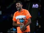 Rohan Bopanna of India holds his trophy after he and partner Matthew Ebden won the Australian Open 2024