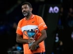 Rohan Bopanna of India holds his trophy after he and partner Matthew Ebden of Australia defeated Simone Bolelli and Andrea Vavassori of Italy in the men's doubles final at the Australian Open tennis championships 