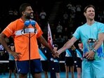 Rohan Bopanna, left, of India and Matthew Ebden of Australia react after receiving their trophy.