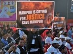 A supporter of the Congress party holds up a banner during Rahul Gandhi's "Bharat Jodo Nyay Yatra" in Manipur's Thoubal district on January 14.