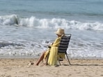 A woman reads in the sun on Victoria beach in Cadiz as temperatures around 30°C were recorded in Spain.&nbsp;(AFP)