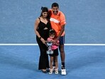 India's Rohan Bopanna poses with his family after victory against Italy's Simone Bolelli and Andrea Vavassori during their men's doubles final match on day 14 of the Australian Open tennis tournament in Melbourne on January 27