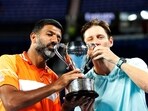 India's Rohan Bopanna and Australia's Matthew Ebden celebrate with the trophy after winning the men's doubles final against Italy's Simone Bolelli and Andrea Vavassori