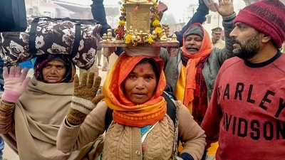 A woman devotee from Maharashtra, carrying a Tulsi plant on her head arrive to offer prayers at the Shri Ram Janmabhoomi Temple, in Ayodhya. IG Range Ayodhya Praveen Kumar assured that all facilities are in place for incoming devotees but appealed to people to visit after winter subsides. (ANI)