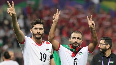 Palestine's forward Mahmoud Wadi and midfielder Oday Kharoub greet supporters (AFP) Palestine's forward Mahmoud Wadi and midfielder Oday Kharoub greet supporters (AFP)