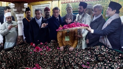 France's President Emmanuel Macron takes part in rituals during his visit of a mausoleum at the Nizamuddin site in New Delhi on January 26. (AFP)