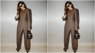 Sonam's pantsuit features a brown-toned top with a short round neckline, baggy full sleeves and an asymmetrical hemline that adds to the chic factor. She paired it with a matching pair of baggy trousers and delivered the lesson on styling monochrome looks like a pro. (Instagram/@sonamkapoor) Sonam's pantsuit features a brown-toned top with a short round neckline, baggy full sleeves and an asymmetrical hemline that adds to the chic factor. She paired it with a matching pair of baggy trousers and delivered the lesson on styling monochrome looks like a pro. (Instagram/@sonamkapoor)