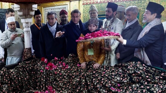 France's President Emmanuel Macron takes part in rituals during his visit of a mausoleum at the Nizamuddin site in New Delhi on January 26.(AFP)