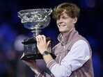Italy's Jannik Sinner celebrates with the Norman Brookes Challenge Cup trophy after defeating Russia's Daniil Medvedev in the men's singles final match on day 15 of the Australian Open tennis tournament in Melbourne on January 28