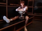 This handout picture released by Tennis Australia on January 29, 2024, shows Italy's Jannik Sinner poses with the 2024 Australian Open men's singles final trophy at the locker room in 