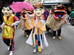 Performers and lion dancers take part in a procession for the upcoming Lunar New Year in Hanoi on January 28, 2024. (Photo by Nhac NGUYEN / AFP)